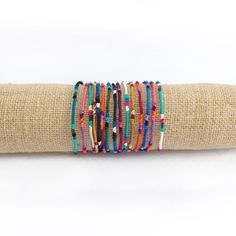 These fair trade Round Silk Friendship Bracelets are handwoven by Guatemalan artisans so each one is unique! The bracelets measure 14" L x .125" W and feature a tie closure. Color combinations and patterns vary. Available in multi color or rainbow. Each purchase empowers Guatemalan artisans. Multicolor Beaded Friendship Bracelets, Multicolor Beaded Friendship Wrap Bracelet, Multicolor Beaded Wrap Bracelet As Gift, Adjustable Multicolor Beaded Friendship Bracelets, Artisan Beaded Multicolor Wrap Bracelet, Artisan Multicolor Beaded Wrap Bracelet, Multicolor Round Beads Wrap Bracelet For Friendship, Multicolor Beaded Wrap Bracelet For Friendship, Multicolor Beaded Friendship Bracelets As Gift