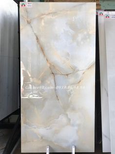 the marble is white and has brown veining on it's sides, along with other materials