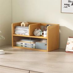 a wooden shelf with books and magazines on it