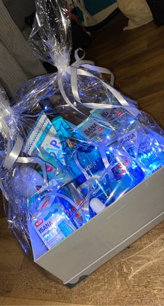 a box filled with blue items on top of a wooden table