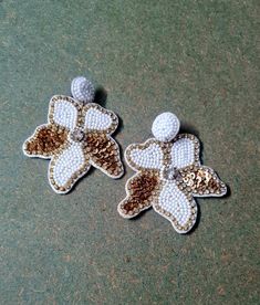 two white and gold flower shaped beaded earrings