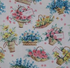 an image of flowers and baskets on a white background with pink, blue, yellow and green flowers