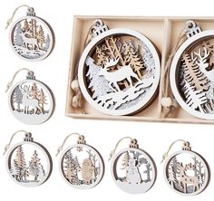 twelve christmas ornaments in a wooden box on a white background, including an ornament