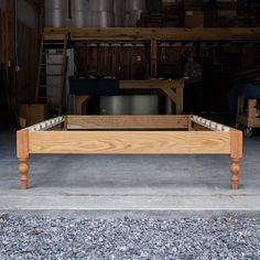 a wooden bed frame sitting in the middle of a garage