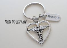 a heart shaped keychain with a medical symbol and thank you written on it