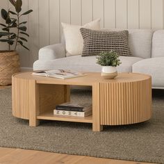 a coffee table sitting on top of a carpeted floor next to a white couch