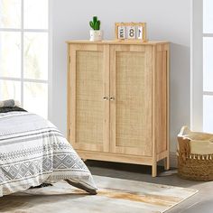 a bedroom scene with focus on the armoire and bed in the foreground, and an area rug on the floor