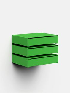 three green drawers are stacked on top of each other in the shape of an object