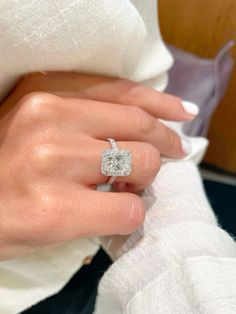 a woman's hand with a diamond ring on it