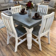 a dining table with chairs around it in a room filled with couches and tables