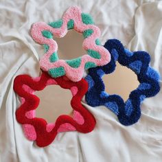 three decorative mirrors sitting on top of a bed