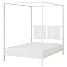 a white bed with a canopy over it