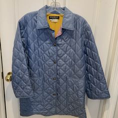 This is a VINTAGE Salvatore Ferragamo quilted silk jacket. The color is a light blue and it has a beautiful abstract print inside lining which is also 100% silk. Two large pockets in front and vents in the back at the bottom of the coat (with snap button closures). The silver metal buttons all say 'Ferragamo'.  The buttons are snap buttons.  The coat looks to be in very good condition--no tears or snags.  It can be worn with the sleeves folded up, or not.  It is probably a 3/4 length sleeve for Blue Winter Outerwear For Daywear, Blue Long Sleeve Outerwear For Daywear, Vintage Blue Outerwear With Button Closure, Vintage Blue Single Breasted Outerwear, Vintage Quilted Outerwear For Spring, Vintage Blue Single-breasted Outerwear, Vintage Blue Long Sleeve Blazer, Vintage Button-up Outerwear For Daywear, Vintage Long Sleeve Outerwear For Daywear