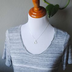 This all sterling silver necklace features a full moon with a textured, cratered surface. The face of the pendant measures approximately 0.65 x 0.53 inches and the back is stamped with my maker's mark and sterling silver quality stamp (925). The chain is a beveled cable chain and is shown at 18 inches long on the mannequin. Choose your chain length from the drop down menu. ★ All orders come wrapped in a gift box, ready for gifting ★ Sterling Silver Moon Charm Necklace With Oval Pendant, Everyday Sterling Silver Moon Charm Necklace, Everyday Moon Shape Sterling Silver Charm Necklace, Everyday Moon Shaped Sterling Silver Charm Necklace, Minimalist Stamped 925 Round Pendant Necklace, Sterling Silver Moon Charm Round Pendant Necklace, Sterling Silver Moon Necklace With Coin Pendant, Moon Shaped Sterling Silver Necklace With Coin Pendant, Sterling Silver Round Pendant Charm Necklace With Moon Charm