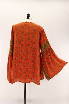 Billowy and romantic, this buttery soft blouse features a v-neckline and bell sleeves. Made from vintage rasgulla silk saris. Available in 3 sizes* S 6-10 M 12-14 L 16-18 Approximately 30” long *Tags were updated with new size designations. Blouse measurements did not change. Some tags will reflect the previous sizing designations. Tag changes are as follows… S/M to S L/XL to M XXL to L Care Instructions: Hand wash and line dry for longest life. Disclaimer: The material used in this style is rep 70s Blouse Bell Sleeves, Semi-stitched Silk Bohemian Blouse Piece, Bohemian V-neck Blouse With Gathered Sleeves, Bohemian Blouse With Gathered Sleeves, V-neck, Butterfly Blouse, Blouse Measurement, Bell Sleeves, Silk