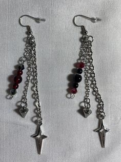 ✦✦ This listing is for the earrings alone but in my shop there is a matching necklace, check it out if you're interested! It will be under the section titled "Necklace" named "Vampires Revenge Necklace" ★ Handmade beaded earrings ✦✦ Because each earring is handmade, they may vary from each other slightly. ★ Length: Around 3.5 - 4 inches ★ Made from stainless steel eye-pins, stainless steel chains, & stainless steel ear wire ★ The beads are made from glass, the Spike Charm is stainless steel, & t Grunge Beaded Jewelry, Alt Earrings, Black And Silver Earrings, Alternative Accessories, Vampire Jewelry, Grunge Earrings, Jewelry Goth, Handmade Beaded Earrings, Goth Earrings