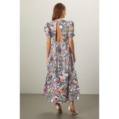 Multicolored floral print (100% Cotton). Casual dress. Short sleeves. Crew neck. Back button closure. 54" from shoulder to hemline. Imported. Printed A-line Maxi Dress For Garden Party, Feminine Floral Print Midi Dress For Casual Wear, Feminine Floral Print Midi Dress For Day Out, Chic Floral Print Dress For Day Out, Multicolor Tropical Print Midi Dress For Day Out, Printed Knee-length Midi Dress For Garden Party, Multicolor Floral Dress With Vibrant Print For Day Out, Chic A-line Dresses With Ditsy Floral Print, Printed Multicolor Floral Dress For Day Out