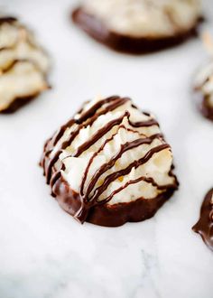 chocolate covered cookies with white frosting and drizzled on the top one