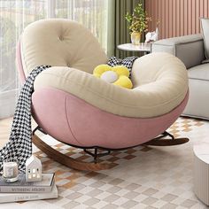 a living room with a rocking chair, coffee table and couch in the corner next to a window