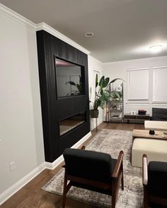 a living room with black and white furniture