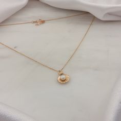 "\"Pearl in SeaShell Necklace | AAA Quality Pearl in Oyster Clam Oceanic Nautical Charm Pendant with Gold Chain Necklace | 14K Solid Gold\" ∙ P R O D U C T I O N ∙ ‣ All of our products are handmade and made to order ‣ All of our items are 14K real gold. We do not carry any gold filled, gold plated, or gold vermeil items. Also there are no other metals used so all items are hypoallergenic. ‣ Raw materials are coming from historical gold and jewelry market of Istanbul Grand Bazaar. The Grand Baza Ocean-inspired Pearl Charm Jewelry As Gift, Ocean-inspired Pearl Charm Jewelry For Gifts, Ocean-inspired Pearl Charm Jewelry Gift, Ocean-inspired Pearl Pendant Jewelry As Gift, Ocean-inspired Pearl Pendant Jewelry Gift, Ocean-inspired Round Gold Necklace, Ocean-inspired Pearl Pendant Necklaces As Gifts, Dainty Shell-shaped Pearl Charm Jewelry, Ocean-inspired Pearl Necklace As Gift