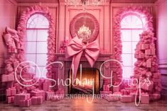 a room decorated with pink bows and presents