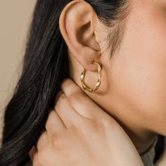 Our Ripple Hoop Earrings are inspired by the ripple effect that a pebble can cause in the ocean - these hoops stand as a reminder that you can have a ripple effect on the world with even the smallest action. Materials & Warranty Material: Real 18 karat gold plating on pure stainless steel Hypoallergenic | Sensitive Skin-Friendly Warranty: Lifetime Warranty against all rust or tarnish Packaging: Nominal Velvet Drawstring Pouch Earrings cannot be returned or exchanged due to hygienic safety Modern Twist Hypoallergenic Hoop Earrings, Modern Twist Hypoallergenic Hoop Earrings As Gift, Trendy Twisted Everyday Hoop Earrings, Modern Twist Hypoallergenic Hoop Earrings For Gifts, Trendy Twisted Hoop Earrings For Everyday, Modern Twist Round Earrings For Everyday, Modern Twist Everyday Earrings, Modern Twist Nickel Free Hoop Earrings, Modern Twist Nickel-free Hoop Earrings