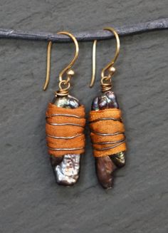 That Warm Feeling - Warm honey, golden sunlight, when your best friend is sharing that perfect moment. These earrings are of hand dyed silk, hand wrapped in oxidized brass around fresh water pearls. They measure 4.5 cm. in total length. They are 10 mm. in width. As with every thing in my shop, 10% of this sale will go to buyer's choice of valid charity. Please state choice at time of sale. Live in peace Walk in light. Kindness, Anna One Of A Kind Artsy Dangle Jewelry, One Of A Kind Drop Earrings For Gift, Bohemian Handmade Gold Wrap Earrings, Bohemian Gold Handmade Wrap Earrings, Artsy Wire Wrapped Earrings Gift, Bohemian Wire Wrapped Wrap Earrings Gift, Handmade Unique Wrap Earrings, Artsy Wire Wrapped Jewelry For Gifts, Artsy Wire Wrapped Jewelry Gift