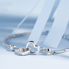 This beautiful Double Heart Sterling Silver Bracelet is the perfect way to show your loved one how much you care. This bracelet features two hearts intertwined with each other, symbolizing the strength of love. Cubic Zirconia stones add a touch of sparkle and glamour, making this beautiful piece of jewelry the perfect gift for that special someone in your life. Additional Product Specification: Metal Material: Sterling SilverLength: 16+3 cm Daughter Bracelet, Cheap Bracelets, Sister Bracelet, Sisters By Heart, Soul Sisters, Silver Bangle Bracelets, Double Heart, Sterling Silver Heart, Crystal Heart