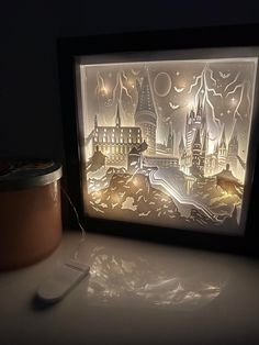 a lit up paper cut artwork with a toothbrush next to it on a table