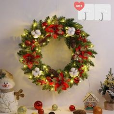 a christmas wreath on the wall with decorations around it