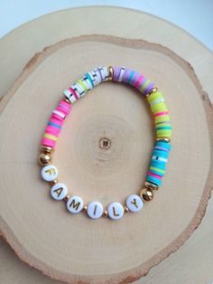 A heishi bead stretch bracelet in a beautiful, colour block pattern made up of bright summer colours. The perfect gift for mum, a sister, friend or teacher! Each bracelet is personalised with the word, name or initial(s) of your choice. Our bracelets are high quality and made to last, but are made from a delicate material. We recommend not to wear them in the shower or while swimming. Bracelets Clay, Bead Stretch Bracelets, Clay Bead Bracelets, Order Letter, Heishi Bracelets, Summer Colours, Bracelet Initial, Letter Bracelet, Clay Bead