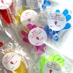 there are many different colored candies in plastic bags with stickers on the top