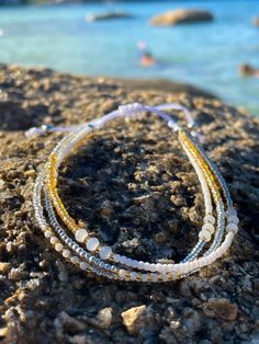 Hard-wearing, multi-strand Japanese seed bead anklet with white waterproof cord with gold, silver and white sparkling beads.  Fully adjustable (22-30cm) with slip-knot. 🌊 🏊✅ Pool & ocean proof.  📦✅ Shipped FREE in the UK and dispatched on the SAME DAY where possible. 🎁✅ Gift wrap option available.  Visit our Etsy site to view other Ben's Beach jewellery --> https://www.etsy.com/uk/shop/BensBeach 🌐 Visit our main site --> https://bensbeach.com/ to view our wider selection and subscribe for u Gold Strand Beaded Bracelets For Summer, Resizable Gold Beaded Bracelets For The Beach, Gold Friendship Bracelets With Colorful Beads For The Beach, Adjustable Silver Beaded Bracelets For Beach, White Tiny Beads Friendship Bracelets For Beach, Silver Adjustable Strand Beaded Bracelets, Gold Beaded Anklets For Beach, Adjustable Silver Beaded Strand Bracelets, Silver Beaded Bracelets With Tiny Beads For Beach