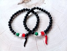 Slim and understated 6mm stretch bead Cornicello bracelet designed with a touch of Italian style: black glass beads, a 3/4" silver stainless steel Horn in your choice of black or red enamel, and three beads evocative of the colors of the flag of Italy. 🖤 All unisex custom handmade made-to-order sizes available from XXS to XXL+ UNISEX WRIST SIZING ~ Every piece is made to order so it's important that you measure your wrist accurately. To ensure a perfect fit, please see the measuring chart in th Trendy Black Bracelets With Colorful Beads, Casual Beaded Bracelets With Black Beads As Gift, Casual Black Stretch Bracelet With Colorful Beads, Casual Black Beads Stretch Bracelet Gift, Casual Black Beads Stretch Bracelet, Casual Black Beaded Bracelet, Bohemian Black Stretch Bracelet As A Gift, Black Bohemian Stretch Bracelet Gift, Bohemian Black Stretch Bracelet As Gift