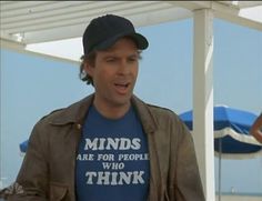 a man wearing a t - shirt that says minds are for people who think