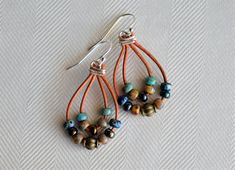 Multi Color Picasso Dangling Earrings. These Earrings are made with picasso miyuki beads and metal beads on light brown natural distressed leather cord, they are approximately 2'' long and hooks are silver plated.  The Earrings are stunning, something that will catch lots of compliments. They are lightweight, will compliment your look. The Earrings will make priceless addition to your handmade jewelry collection. Great gift for someone special as well! Please contact me if you have any questions Bohemian Wrap Earrings With Ear Wire, Bohemian Dangle Wrap Earrings, Bohemian Dangle Wrap Earrings For Pierced Ears, Bohemian Wrap Dangle Earrings With Ear Wire, Bohemian Wire Wrapped Adjustable Wrap Earrings, Bohemian Wrap Dangle Earrings, Bohemian Adjustable Wire Wrapped Wrap Earrings, Bohemian Adjustable Wrap Earrings For Festival, Adjustable Bohemian Beaded Wrap Earrings