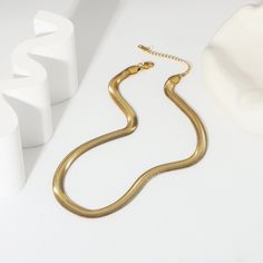 The Bold Herringbone Necklace in 18k gold plating makes a striking statement. Its wide, sleek design captures light beautifully, adding an element of sophisticated shine to any outfit, from casual to formal. Elegant Gold Herringbone Necklace With Adjustable Chain, Elegant Gold Herringbone Choker Necklace, Elegant Herringbone Clavicle Necklace, Elegant Metal Herringbone Clavicle Necklace, Chic Gold Herringbone Necklace With Adjustable Chain, Elegant Gold-plated Herringbone Necklace, Gold Herringbone Necklace For Everyday Wear, Chic Gold Herringbone Chain Necklace, Chic Gold Herringbone Necklace With Delicate Chain