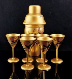 a set of six wine goblets sitting next to each other on a table