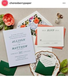 the wedding stationery is laid out on top of each other, including two envelopes and