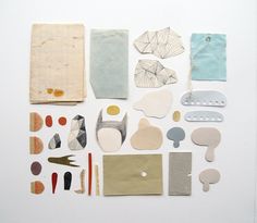 an assortment of crafting supplies laid out on a white surface