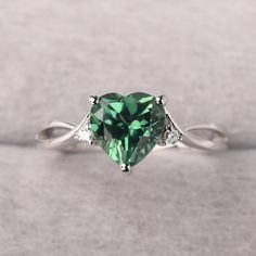 ◆ The ring is handcrafted from sterling silver and decorated with a dazzling 8*8 mm green sapphire and CZs. It is suitable for engagement/anniversary/daily occasion. ◆ Production Description: Main stone Type: Lab Green Sapphire Main Stone Shape: Heart Cut Main Stone Size: 8*8 mm(2.59ct) Side stone: CZ Metal: 925 Sterling silver - Other options available in the drop down menu ◆ Customization: √Free for Add Engraving √Other Metal Type Available √Other Gemstones & Shapes Available √Personalization Sage Green Promise Rings, Green Promise Rings For Her, Green Gem Rings, Green Diamond Birthstone Ring For Promise, Green Sapphire Rings With Prong Setting, Green Diamond Ring With Center Stone For Proposal, Fine Jewelry Green Diamond Promise Ring, Green Diamond Birthstone Ring With Accent Stones, Green Emerald Ring With Brilliant Cut For Promise