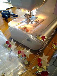 the sewing machine is sitting on the table next to some plastic bags and other items