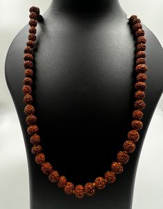 Immerse yourself in the sacred energy of our meticulously crafted Rudraksha Mala featuring 7mm beads. Handcrafted from authentic Rudraksha seeds, each bead carries a rich history of spiritual significance. Rudraksha beads are revered for their ability to enhance meditation, promote mindfulness, and attract positive energies. Key Features: Authentic Rudraksha Seeds: Sourced with care, each 7mm bead is a genuine Rudraksha seed, known for its powerful spiritual vibrations. Meticulous Craftsmanship: Our Rudraksha Mala is handcrafted with precision, ensuring the integrity of each bead and the overall aesthetic appeal of the necklace. Versatile Meditation Aid: The 7mm bead size strikes a perfect balance, making this mala ideal for both beginners and experienced practitioners. Use it for meditati Traditional Mala With Gemstone Beads For Healing, Spiritual Gemstone Beads Mala For Puja, Spiritual Gemstone Mala For Puja, Handmade Spiritual Mala For Puja, Spiritual Round Beads Mala For Puja, Spiritual Mala With 8mm Beads For Rituals, Spiritual Mala With Round Beads For Puja, Spiritual Healing Mala With Round Beads, Hand-strung Spiritual Mala For Puja