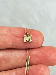 "Delicate and simple sterling silver initial letter necklace, it is perfect if you want a personalized gift for a friend, sister, mother, daugther or for yourself. So beautiful, cute and mini. Necklace and letter are made of 925 sterling silver. Pendant size is 5mm * Gold initials are made of bronze and plated with 18Kt gold. * 925 Sterling silver box chain plated with 18 kt gold. Our jewelry is packaged in a beautiful gift box. If this necklace is a gift, we can ship to third party. Send me a m Dainty Sterling Silver Name Necklace For Everyday, Minimalist Tiny Charm Necklaces For Mother's Day, Dainty Letter Jewelry For Personalized Gift, Everyday Initial Necklace For Mother's Day, Mother's Day Sterling Silver Initial Pendant Charm Necklace, Mother's Day Sterling Silver Charm Necklaces, Dainty Sterling Silver Initial Necklace For Everyday, Minimalist Letter Jewelry For Personalized Gifts, Tiny Initial Pendant Necklace For Gift