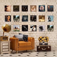 a living room filled with furniture next to a brick wall covered in pictures and posters