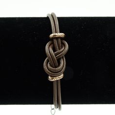 Description Genuine brown Greek Leather (2mm thick) is tied in an infinity knot and accented with antiqued copper. The never-ending infinity knot represents eternity, equilibrium and balance. Wear it as a symbol of your inner balance. Genuine Greek Leather, 2mm thick Bracelet size: choose your size, it will be adjustable +/- a 1/2" around that size Hypoallergenic/Nickel Free: Yes Sizing your bracelet: Please see the Size Guide above or the Sizing tab below for more details. This bracelet is adju Infinity Knot Bracelet, Earth Song, Inner Balance, Infinity Knot, Black Moonstone, Knot Bracelet, Natural Stone Bracelets, Chakra Bracelet, Black Agate