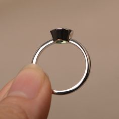 This is a gorgeous handmade creation. Its beauty is its simplicity & Elegance. The 7*7mm round cut lab green sapphire is crafted in solid sterling silver / 14k gold. It is available to customized, if you have any mind, just let me know, we will discuss with it. All item is sent in a beautiful gift box You can realize more lovely stuff clicking the link https://www.etsy.com/shop/knightjewelry?refshopsection_shophome_leftnav Please leave the correct address and you PHONE NUMBER for delivering Silver Tourmaline Emerald Ring, Emerald Bezel Setting Promise Ring For May Birthstone, Emerald Ring With Bezel Setting, Elegant Peridot Stackable Rings For May Birthstone, Green Sapphire Round Ring, Emerald Birthstone Ring With Bezel Setting, Green Jewelry With Bezel Setting And Round Band, Sterling Silver Jewelry With Tension Setting In Round Band, Peridot Gemstone Stackable Rings