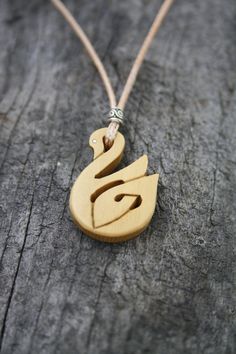 "This very unique Celtic Necklace will be made for you, or a loved one, in my studio on the West of Ireland. This beautiful Celtic Swan pendant features a piece of boxwood, recycled from musical instruments constructed by a local luthier. As a musician myself, I take enormous satisfaction in creating a necklace whose inherent wood has previously featured in a beautiful hand-made flute. Also, part of boxwood's attractiveness is its durability and ability to stand the test of time and of course th Natural Carved Necklaces As Gift, Handmade Wooden Necklace Gift, Natural Spiritual Jewelry As A Gift, Artisan Natural Wood Necklace As A Gift, Artisan Necklace In Natural Wood As A Gift, Artisan Necklaces In Natural Wood As Gift, Artisan Natural Wood Necklaces For Gift, Symbolic Carved Necklace For Gifts, Artisan Wooden Jewelry As A Gift