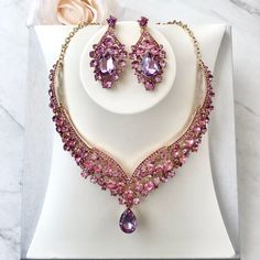 Purple is a favorite wedding color, and it can go well for Spring as well as Winter events. In line with the latest wedding trends, this beautiful three-piece bridal jewelry set is adorned with intricately faceted purple rhinestone crystals that capture the light from every angle with a perfectly translucent appeal. All pieces are rhodium plated for a flawless finish which enhances the intricate detailing and conveys a modern take on old elegance. Necklace: 17" (approx. 43cm) long with a 2" (app Purple Wedding Jewelry Sets, Purple Crystal Jewelry Set For Party, Formal Purple Crystal Jewelry Sets, Luxury Purple Crystal Elegant Necklace, Wedding Jewelry And Accessories, Elegant Purple Multi-stone Necklace, Winter Event, Bridal Jewelry Set, Wedding Accessories Jewelry